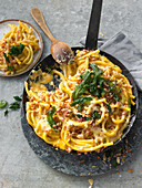 Macaroni with pancetta, pine nuts and cheese sauce