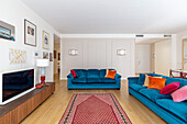 Blue upholstered sofas and TV cabinet in the living room