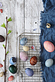 Easter eggs dyed with natural dyes, on cooling rack