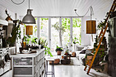 Living room with open kitchen and lots of houseplants