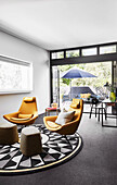 Seating area with designer armchairs on a rug with geometric pattern