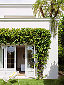 View from yard of patio door framed with bougainvillea