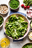 Preparation of a Butter Lettuce Salad, with various salad ingredients