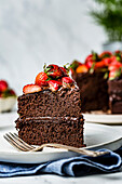 A chocolate cake decorated with fresh chopped strawberries