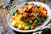 Grilled cooked whole chicken with vegetable garnish