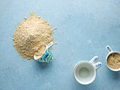 Almond flour and measuring cups on a blue background