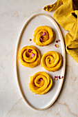 A Mango Rose and rose petals on a plate