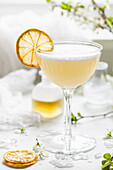 A gin sour flavoured with bergamot and camomile garnished with egg white foam and a slice of dehydrated lemon