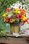 Summer bouquet with edible flowers: daylilies, roses, oregano, Queen Anne's Lace and hollyhock
