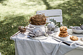 Place setting, yeast pastry and nest on Easter table in the garden