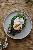 Toast with asparagus, poached egg, greens and ham