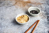 Bowl full of sesame seeds and soy sauce with oil and sesame