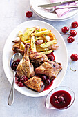 Roast duck with cherries and french fries
