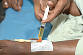 Nurse administering drugs through a cannula