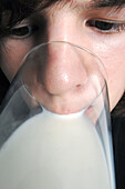 Teenage boy drinking a glass of milk