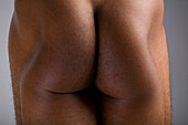 Nude man's buttocks