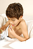 Young boy sick in bed