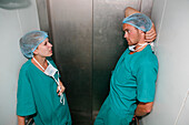 Surgical staff discuss their work schedule in a lift