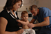 Paediatrician checks a baby's breathing