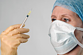 Doctor analysing a syringe specimen