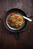 Spaghetti with falafel, pesto and roasted cocktail tomatoes