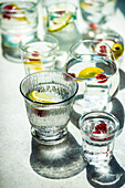 Glasses with lemonn and berry water on concrete background