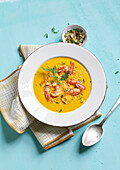Carrot-coconut soup with ginger and prawns