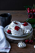 Small pavlovas with cherry sauce