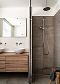 Oak washstand and shower cubicle with cement tiles in bathroom