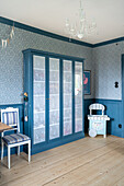 Showcase cabinet in the children's room in vintage style in blue