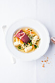 Semolina dumplings in beef bouillon with Flädle (pancake strips) and cured beef boiled fillet