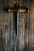 Vintage corkscrew on textured rustic background