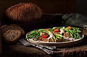 Wild asparagus on three-grain bread with grilled tomatoes and sauce