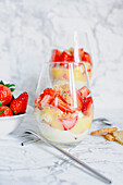 Creamy custard with crumble, egg liqueur and strawberries