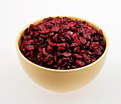 Dried cranberries in a yellow ceramic bowl