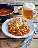 Székely goulash (also Szegediner goulash) with dumplings and beer