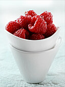 Fresh raspberries in a small white dish