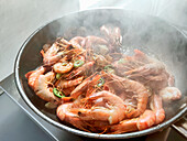 Frying shrimps in a frying pan