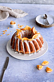 Traditional Bundt Cake with icing and oranges