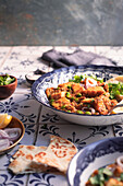 A Vegetarian Indian dish on a tiled kitchen table - Matar Paneer