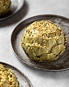 Globe artichoke stuffed with breadcrumbs, herbs and spices