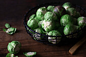 Raw brussel sprouts on a wooden background