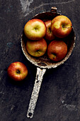 Braeburn apples in an enamel colander