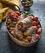 Pork Involtini served in a pan with roasted vegetables