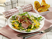 Veal steaks on a spicy rocket and parsley root salad