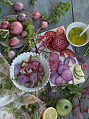 prepping a winter salad with winter radish, beets, apples, and herbs