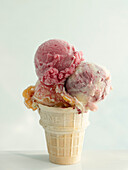 Three scoops of ice cream in a cake cone