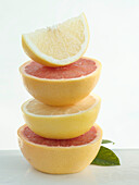 Red and yellow grapefruit halves stacked on top of one another