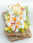 Two slices of crispbread with cottage cheese and vegetables