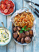 Mincedmeat patties, fried potatoes, tomatoesalad and tzatziki